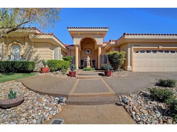 Elegant home featuring manicured landscaping, a tiled roof, and a circular driveway at 4936 Mountain Foliage Dr, Las Vegas, NV 89148
