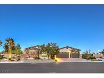 Beautiful single-story home featuring a three-car garage and desert landscaping at 5640 Willow Canyon St, Las Vegas, NV 89149
