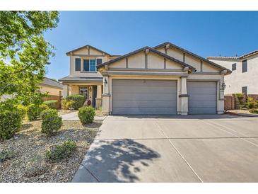 Charming two-story home with a three car garage, manicured landscaping, and a welcoming front entrance at 7349 Merimack Oaks St, Las Vegas, NV 89166