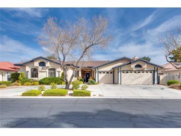 Charming single-story home with mature landscaping, three-car garage and inviting curb appeal at 7432 Tahoe Basin Dr, Las Vegas, NV 89129