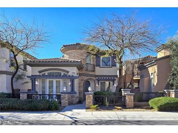 Charming stucco two-story home with stone accents and desert landscaping, enhancing its curb appeal at 7695 Windy Meadow Ave, Las Vegas, NV 89178