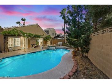 Backyard pool and spa with manicured landscaping and privacy wall at 2163 Fountain Springs Dr, Henderson, NV 89074