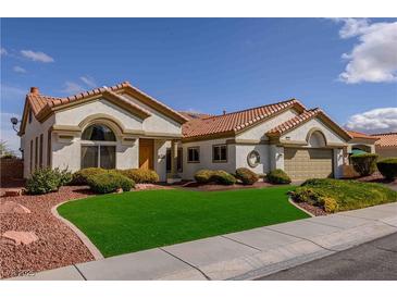 Inviting single story home with lush green artificial lawn and desert landscaping at 2212 Sierra Heights Dr, Las Vegas, NV 89134