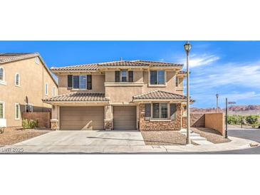 Two-story home with desert landscaping, tiled roof, and a three-car garage at 228 Via Vallisneri, Henderson, NV 89011