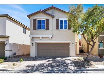 Charming two-story home features a neutral color palette, two-car garage, and manicured front yard with a mature shade tree at 5614 Bishop Flowers St, Las Vegas, NV 89130