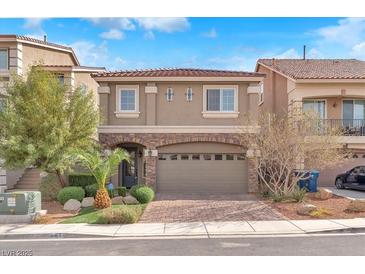 Charming two-story home with red-tiled roof, manicured front yard, and a two-car garage at 5671 Camilla Cellars Ct, Las Vegas, NV 89141