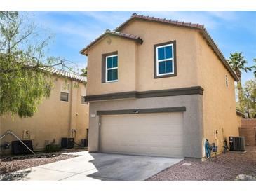 Two-story home showcasing a neutral stucco facade, an attached garage, and well-kept landscaping at 6745 Jackson Junction St, Las Vegas, NV 89149