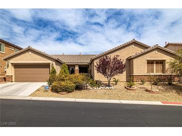Attractive single-story home with a low-maintenance desert landscape and two car garage at 7180 White Bloom Ave, Las Vegas, NV 89117