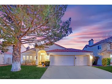 Charming single-story home features a red tile roof, attached two-car garage and a well-manicured front yard at 7405 Blue Sage Ct, Las Vegas, NV 89129