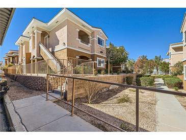 Charming condo complex showcasing stairs leading to upper-level units and well-maintained landscaping at 830 Carnegie St # 724, Henderson, NV 89052