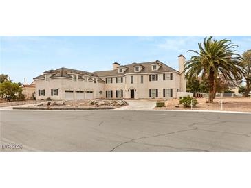 Elegant multi-story home with classic architectural design, three car garage, and meticulously landscaped front yard at 3207 Bel Air Dr, Las Vegas, NV 89109