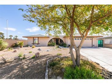 Charming home featuring a well-maintained yard and a driveway leading to an attached two-car garage at 4476 Oakhill Cir, Las Vegas, NV 89121