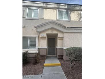 Inviting front entrance with a covered porch and neutral-toned exterior at 6461 Za Zu Pitts Ave # 102, Las Vegas, NV 89122