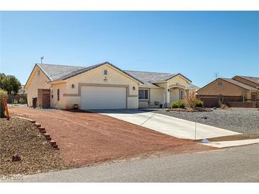 Charming single story home featuring a two car garage and desert landscaping at 6751 Stubblefield Dr, Pahrump, NV 89061