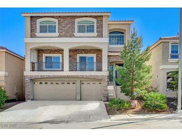 Charming two-story home with stone accents, balcony, three-car garage, and landscaped front yard at 6773 Goose Watch Ct, Las Vegas, NV 89139