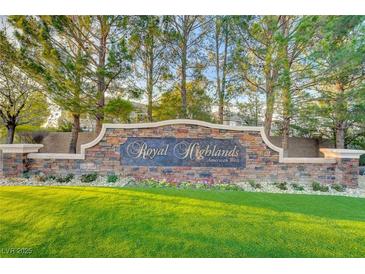 Royal Highlands community sign featuring manicured lawn, stone design, and colorful flowers at 10965 Ladyburn Ct, Las Vegas, NV 89141
