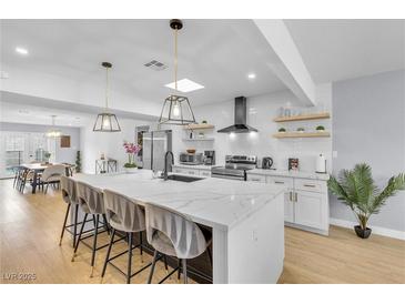 Stunning kitchen featuring a large island, modern appliances, and stylish pendant lighting at 3611 Valencia St, Las Vegas, NV 89121