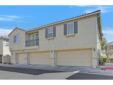 Three-story home with a three-car garage, charming balcony, and neutral stucco finish at 3920 Sweet Pine St # 102, Las Vegas, NV 89108