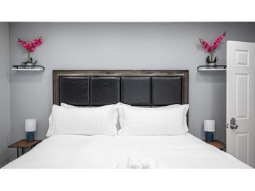 Comfortable bedroom features a padded headboard and stylish decor at 120 Chartan Ave, Las Vegas, NV 89183