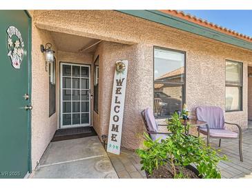 Inviting front porch with charming decor and cozy seating, great curb appeal and a welcoming entrance at 209 Crosswind Way, Las Vegas, NV 89145