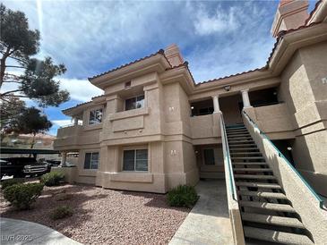 Inviting condo exterior with well-maintained landscaping and stucco finish in a sunny setting at 340 Manti Pl # 0, Henderson, NV 89014