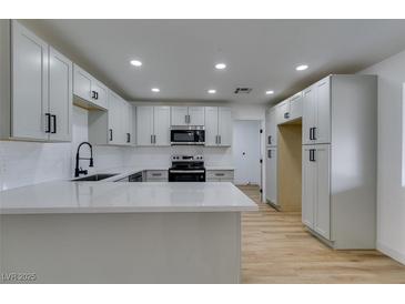 Bright kitchen with white cabinets, modern hardware, and stainless steel appliances at 4670 E Boston Ave, Las Vegas, NV 89104