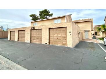 View of the garages with a two story apartment above, showing the front of the complex at 5245 Golden Ln, Las Vegas, NV 89119