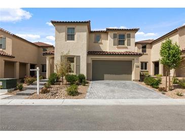 Charming two-story home with a two-car garage, desert landscaping, and a brick paver driveway at 6545 Vanhoven Crest St, Las Vegas, NV 89166