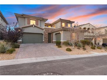 Charming two-story home featuring a neutral color scheme, dual garages, stone accents, and desert landscaping at 193 Elder View Dr, Las Vegas, NV 89138