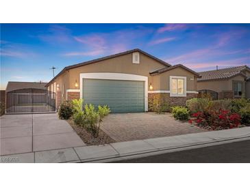 Charming single-story home featuring desert landscaping, a two-car garage, and a secure gated entrance at 2091 Hunt Woods Ct, Laughlin, NV 89029