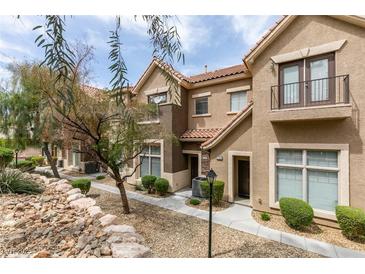 Charming townhouse featuring desert landscaping, a private balcony, and a well-maintained exterior at 2787 Fountain Ridge Ln, Henderson, NV 89074