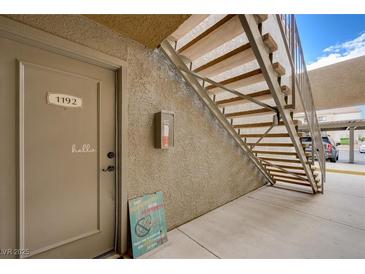 Apartment entrance featuring the door to unit 1192 and stairway access at 3151 Soaring Gulls Dr # 1192, Las Vegas, NV 89128