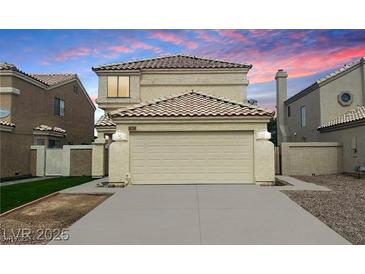Two-story home featuring a beige exterior, two-car garage, and desert landscaping at 367 Lander Dr, Henderson, NV 89074
