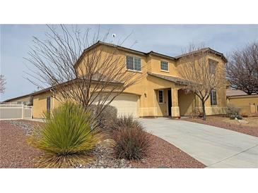 Charming two-story home featuring a desert landscape, neutral stucco, and attached two car garage at 3938 E Chaffe Ave, Pahrump, NV 89061