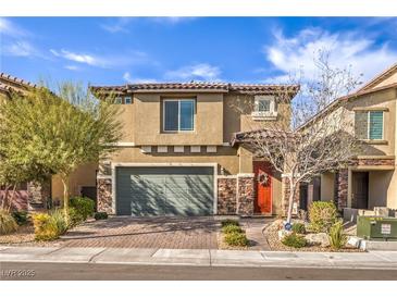 Inviting two-story home featuring a two-car garage, stone accents, and a well-maintained front yard at 4442 Solitude Falls Ave, North Las Vegas, NV 89084