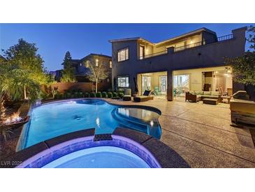 A luxurious backyard featuring a pool and spa with an outdoor living space, perfect for entertaining at 6491 Wild Blue Ct, Las Vegas, NV 89135