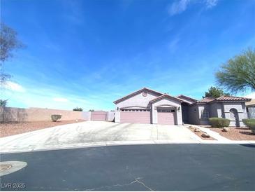 Charming single-story home with a spacious driveway and a well-manicured front yard at 6628 Martinsville Pl, Las Vegas, NV 89110