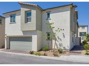 Beautiful new two-story home featuring an attached garage and well manicured landscaping in a modern community at 7017 Magenta Moon St, North Las Vegas, NV 89086