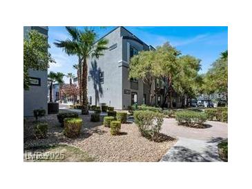 Beautiful exterior view of a modern condo building with a well-maintained landscape design at 9050 W Tropicana Ave # 1009, Las Vegas, NV 89147