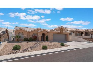 Charming single-story home featuring desert landscaping, a tile roof, and an attached two-car garage at 1010 Armillaria St, Henderson, NV 89011