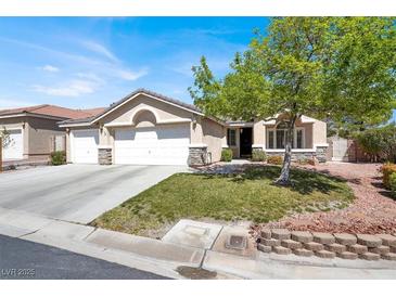 Charming single-story home featuring a manicured lawn, mature tree, and a spacious three-car garage at 10200 Clark Wooldridge Ct, Las Vegas, NV 89129