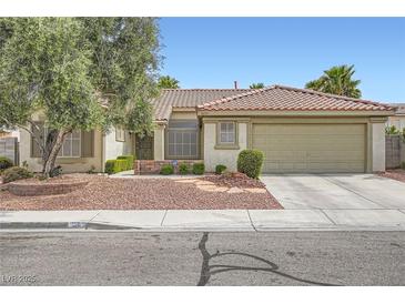 Charming single-story home with a well-maintained front yard and attached two-car garage at 1633 Broken Feather Dr, North Las Vegas, NV 89031