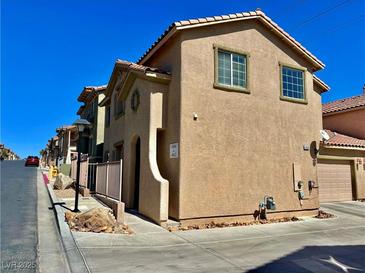 Charming townhome showcasing a two-story design with a well-kept desert landscape and a red tiled roof at 4046 Sparrow Rock St, Las Vegas, NV 89129