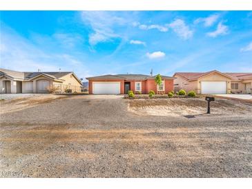 Charming single-story home with desert landscaping and a spacious two-car garage at 6661 Gallup Ct, Pahrump, NV 89060