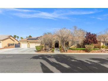 Charming single-story home featuring a three-car garage, well-manicured landscaping, and solar panels at 8220 Tursi Lodge Ct, Las Vegas, NV 89131