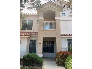 Charming townhome showcasing a private balcony, neutral stucco, and a red tile roof at 8555 W Russell Rd # 1078, Las Vegas, NV 89113