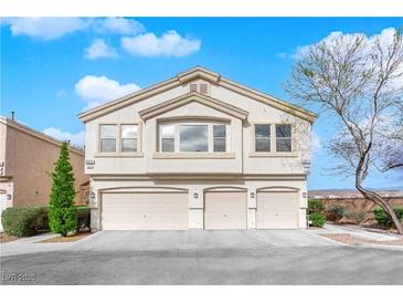 Inviting townhouse featuring a neutral color scheme, attached garages and well maintained landscaping at 9315 Indian Corn Ct # 101, Las Vegas, NV 89178