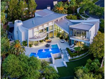 Striking aerial view of a luxury home with a private pool, patio, and lush landscaping at 1108 Pine Island Ct, Las Vegas, NV 89134
