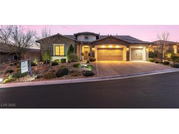 Charming single-story home featuring a three-car garage, meticulously landscaped front yard, and inviting entrance at 12169 Castilla Rain Ave, Las Vegas, NV 89138