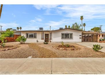 Charming single-story home with desert landscaping and a covered carport at 2021 N Michael Way, Las Vegas, NV 89108